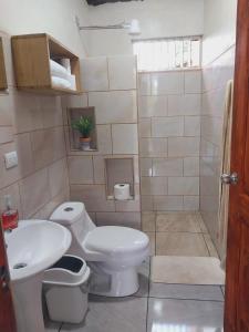 a bathroom with a toilet and a sink at Escapadita Pura Vida in Fortuna