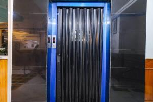 a metal door with blue trim in a building at FabHotel Nand in Patna