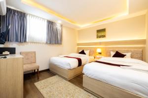 Voodi või voodid majutusasutuse Divine Kathmandu Hotel toas