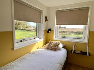 Ένα ή περισσότερα κρεβάτια σε δωμάτιο στο Holiday Home in Texel near De Hors Reserve