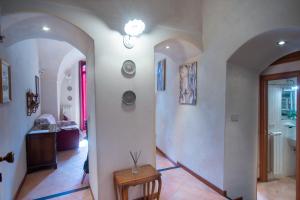 korytarz z łukiem i stołem w pokoju w obiekcie Casa di Lella - Happy Rentals w San Remo