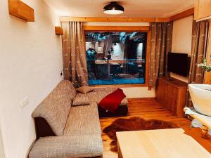 a living room with a couch and a television at Zottlhoamat in Matrei in Osttirol
