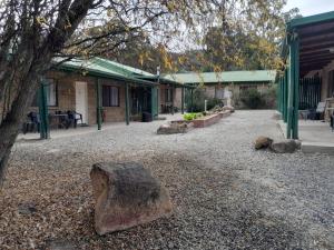 a large rock sitting on the ground next to a building at Murray Gardens Motel in Stanthorpe