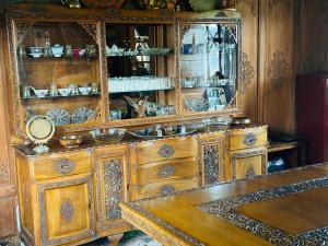 an ornate wooden cabinet with a mirror on top of it at Maharaja palace houseboat in Srinagar