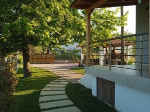 a walkway in a park with trees and a gazebo at Villa Panagia in Ormos Panagias