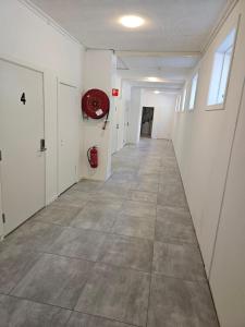 an empty hallway in a building with a fire hydrant at Brufjell Hostel & Parking in Flekkefjord