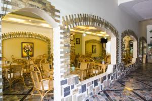 a restaurant with chairs and tables in a room at Spring Hotel in Can Tho