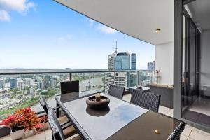 a dining room with a view of the city at Urban Skyline 2-Bed with Pool & Gym Access in Brisbane