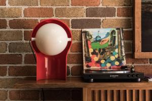 a red sculpture on a shelf next to a brick wall at Sea Sea Hotel in Crescent Head