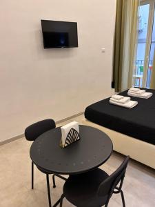 a room with two beds and a table and chairs at Olina residence 2 in Naples