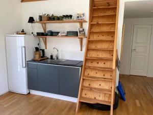 a kitchen with a ladder next to a sink and a refrigerator at 4 star holiday home in Sparreholm in Sparreholm +23 photos