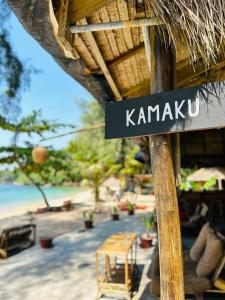 a sign that says karmau on a beach at KAMAKU Bungalows in Koh Rong Sanloem