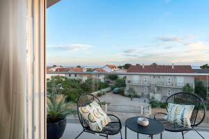 a balcony with two chairs and a table and a view at Apartments Stella Per Te in Vir
