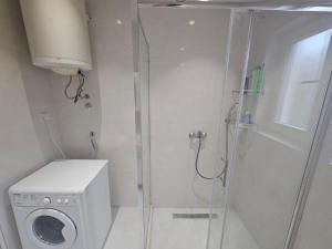 a bathroom with a shower and a washing machine at Rooms Vlaovic in Herceg-Novi +15 photos
