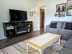 a living room with a couch and a tv at Your Home Away from Home in Payette