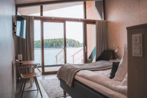 a room with a bed and a large window at Bella Lake Resort in Kuopio