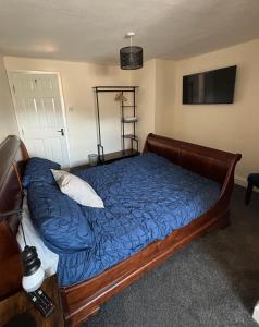 a bedroom with a bed with a blue comforter at Half Moon Inn in Middlesbrough