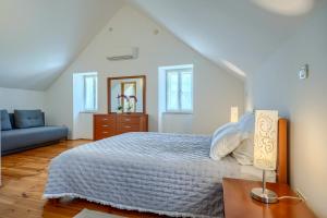 a white bedroom with a bed and a couch at Villa Bonaca Cozy Family & Friends Retreat with Heated Pool in Sumartin +62 photos