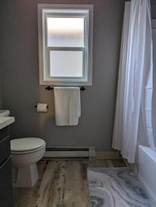 a bathroom with a toilet and a window at Your Home Away from Home in Payette