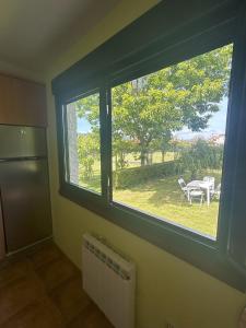 a room with a window with a table and a table at Grupo Gontad Casa Ponteceso Outrabanda 2 in Ponteceso