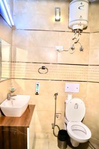 a bathroom with a toilet and a sink at Divine India Service Apartment 3 BHK D-198 Saket in New Delhi