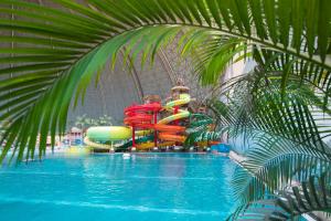 a pool with a water park with a water slide at Tropical Islands in Krausnick