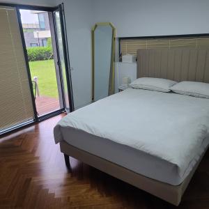 a bedroom with a large bed and a large window at Wind Flower in Seogwipo