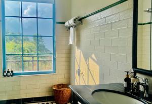 a bathroom with a sink and a window at Faraway Cottages, Auli in Joshīmath
