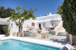 a villa with a swimming pool and a house at Kallos Villas & Suites in Naxos Chora