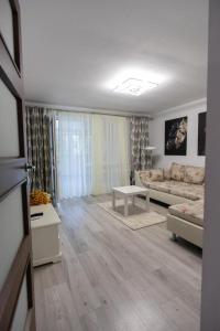 a living room with a couch and a table at Classic Apartament in Buzău