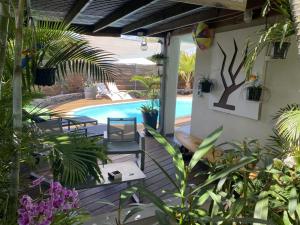 a patio with a pool and a bunch of plants at P'ti coin zen in Saint-Gilles-les-Bains +38 photos