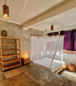 Schlafzimmer mit einem Bett mit Moskitonetz in der Unterkunft Vertical House Bali in Uluwatu