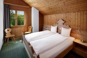 a bedroom with a large bed in a wooden room at Hotel und Naturhaus Bellevue in Seelisberg