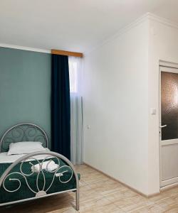 um quarto com uma cama, uma janela e uma porta em Hotel Sunny em Akhaltsikhe