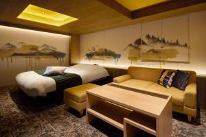 Кровать или кровати в номере Yatomi Hotel Nuqu Natural Hot Spring