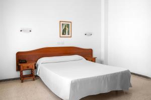 Posteľ alebo postele v izbe v ubytovaní Hotel Valencia