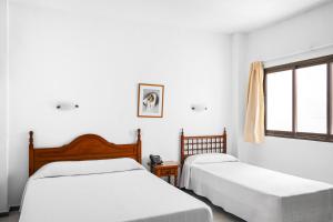 Posteľ alebo postele v izbe v ubytovaní Hotel Valencia