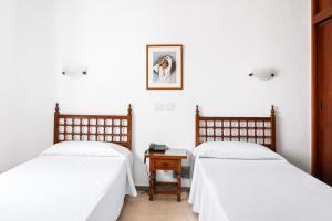 Posteľ alebo postele v izbe v ubytovaní Hotel Valencia