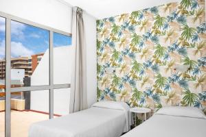 Posteľ alebo postele v izbe v ubytovaní Hotel Valencia