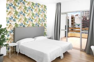 Posteľ alebo postele v izbe v ubytovaní Hotel Valencia