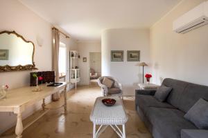a living room with a couch and a table at Dependance a Baglio il Corvo by Wonderful Italy in Gangi +17 photos