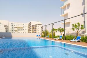 an image of a swimming pool in a building at Poolside Charm in Abu Dhabi