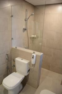 W łazience znajduje się toaleta i przeszklony prysznic. w obiekcie فندق فيفتى ايت السالمية w Kuwejcie