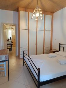 a bedroom with a bed and a dining room at Athina Studio Apartments in Kerveli
