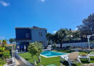 a villa with a swimming pool and a house at Villa Andres B&B in Sassari