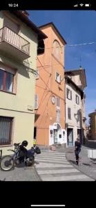 a motorcycle parked on a street next to a building at Casa dell’Annunziata in Chiusa di Pesio