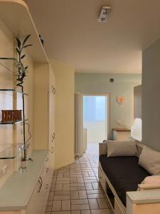 ein Wohnzimmer mit einem Sofa und einer Küche in der Unterkunft Alba Apartment - Only Family in Riccione