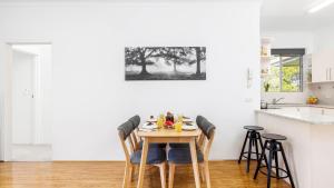 a dining room with a table and chairs at Beachside at Gretel in Nelson Bay