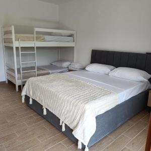 a bedroom with a bed and a bunk bed at Eva & Resul apartments in Ilias