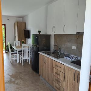 a kitchen with a black refrigerator and a table at Eva & Resul apartments in Ilias +9 photos
